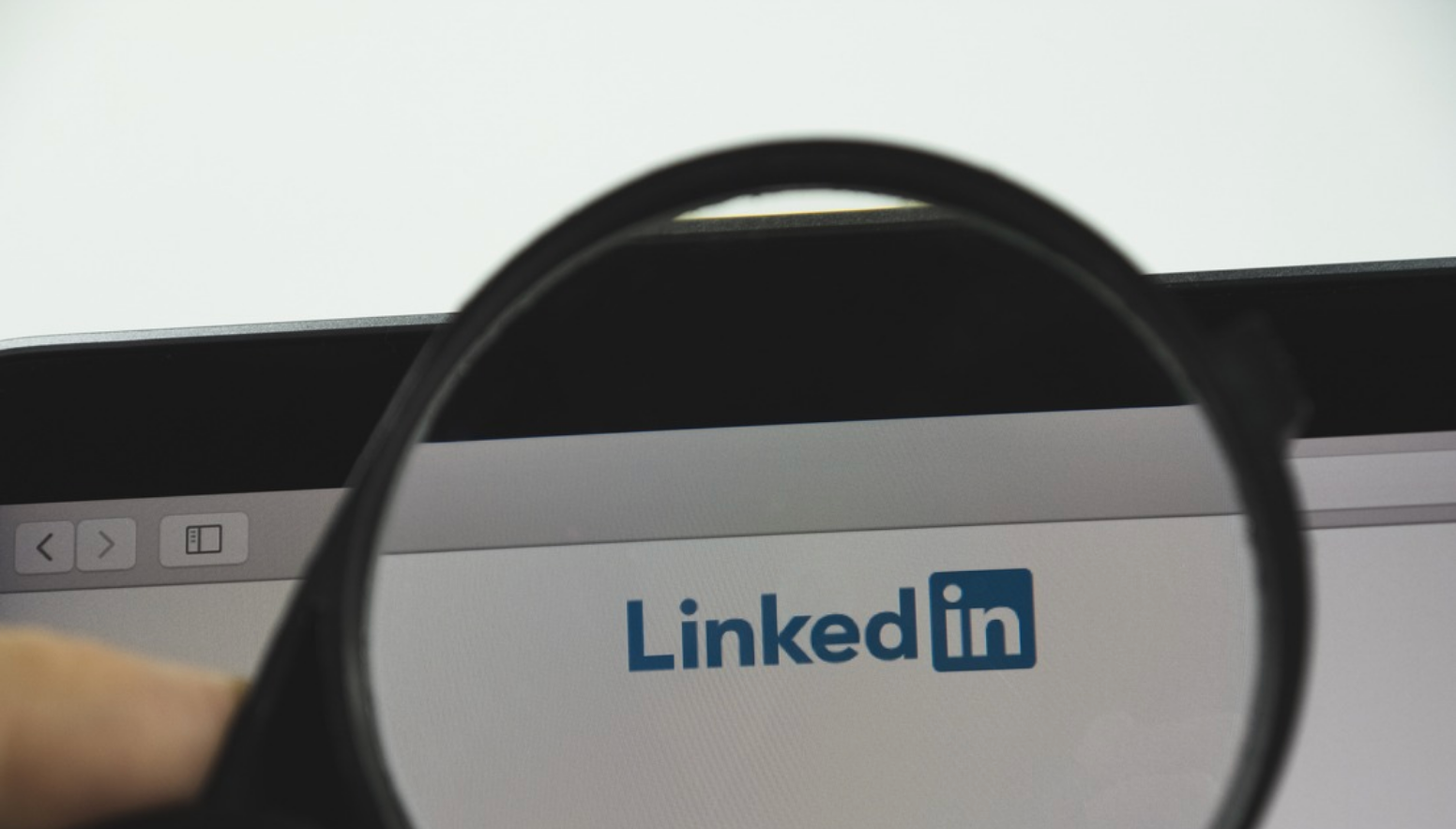 The LinkedIn logo seen through a magnifying glass